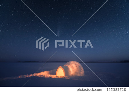 Wintry scene with snowy igloo and starry night sky Wintry scene with snowy igloo and starry night sky 135383728