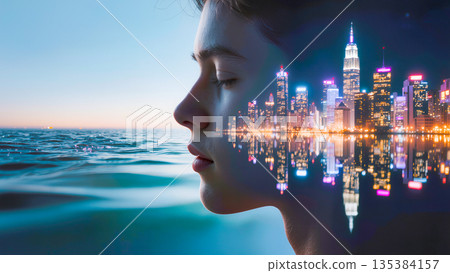 An artistic side profile of a young person with eyes closed, seamlessly blended with a vibrant nighttime cityscape. The glowing skyscrapers and their reflections in the water are superimposed onto the 135384157