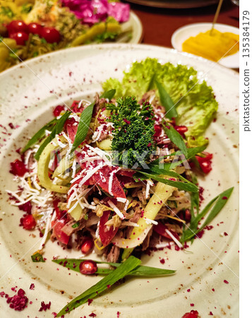 A plate of food with a green leaf on top A plate of food with a green leaf on top 135384179