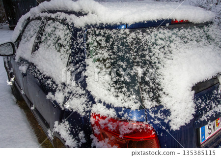 Four-wheel drive car covered with snow and ice 135385115