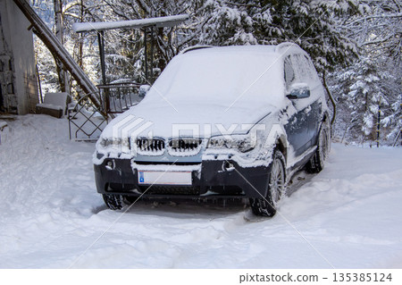 Four-wheel drive car covered with snow and ice 135385124