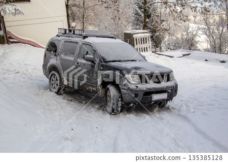 Four-wheel drive car covered with snow and ice Four-wheel drive car covered with snow and ice 135385128