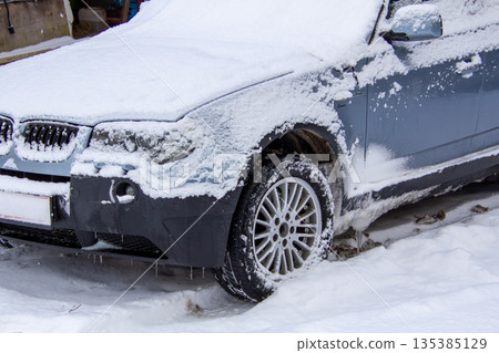 Four-wheel drive car covered with snow and ice 135385129