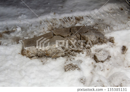 Road salt fallen from the bottom of a car 135385131