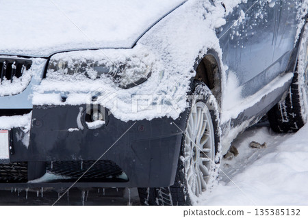 Four-wheel drive car covered with snow and ice 135385132