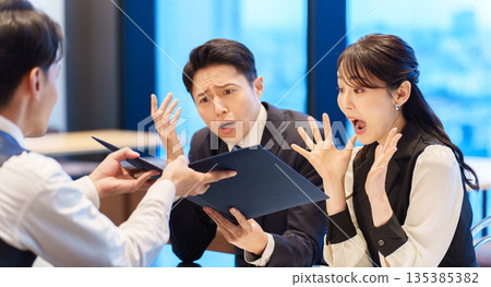 Surprised couple looking at a restaurant menu Surprised couple looking at a restaurant menu 135385382