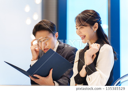 A man anxious about a restaurant menu A man anxious about a restaurant menu 135385529