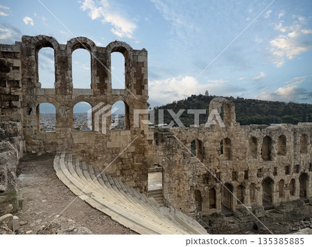 Ancient Odeon of Herodes Atticus Amphitheater Ruins With Tiered Stone Seats And Arched Walls, Athens Greece Ancient Odeon of Herodes Atticus Amphitheater Ruins With Tiered Stone Seats And Arched Walls, Athens Greece 135385885