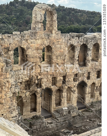 Ancient Odeon of Herodes Atticus Amphitheater Ruins With Tiered Stone Seats And Arched Walls, Athens Greece Ancient Odeon of Herodes Atticus Amphitheater Ruins With Tiered Stone Seats And Arched Walls, Athens Greece 135385889