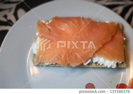 Gourmet salmon dish featuring smoked or raw cuts with toast or rice. Gourmet salmon dish featuring smoked or raw cuts with toast or rice. 135386376