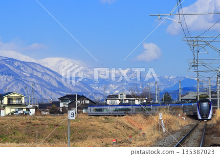 Azusa train of E353 series running leisurely under the watchful eye of the beautiful Northern Alps mountains. Photographed on 12/7/2025. Azusa train of E353 series running leisurely under the watchful eye of the beautiful Northern Alps mountains. Photographed on 12/7/2025. 135387023