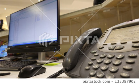 Office Workspace with Phone and Computer Monitor 135387902