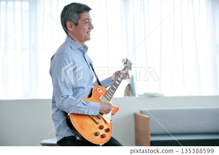 Senior man playing electric guitar Senior man playing electric guitar 135388599