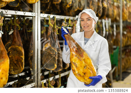 young specialist keeps a large jamon in the workshop young specialist keeps a large jamon in the workshop 135388924