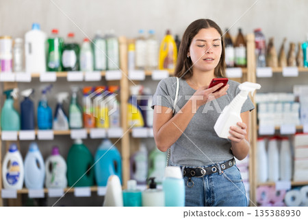 Woman scanning package with spray 135388930