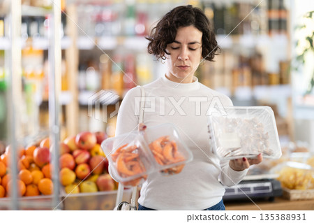 Adult woman chooses prawns or purple dye murex (Bolinus brandaris) 135388931