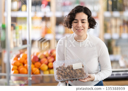 Adult woman chooses purple dye murex or spiny dye murex (Bolinus brandaris) 135388939