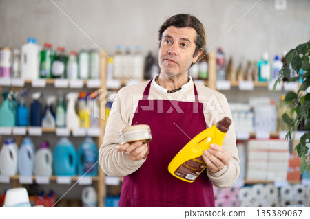 Male seller offers products for wood and parquet Male seller offers products for wood and parquet 135389067