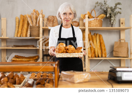 Senior woman seller of bakery store is standing in trading floor, waiting for visitors 135389073