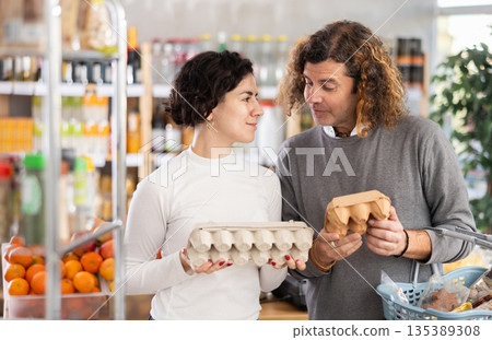 Couple picking eggs Couple picking eggs 135389308