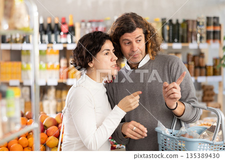 Married couple is looking for fresh produce together in grocery supermarket 135389430
