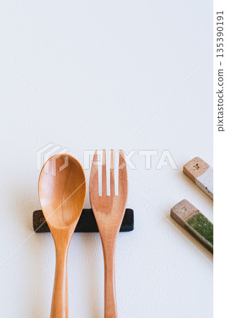 Wooden spoon and fork and cutlery rest on white background 135390191