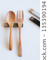 Wooden spoon and fork and cutlery rest on white background 135390194
