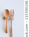 Wooden spoon and fork and cutlery rest on white background 135390196