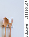Wooden spoon and fork and cutlery rest on white background 135390197