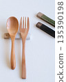 Wooden spoon and fork and cutlery rest on white background 135390198