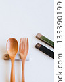 Wooden spoon and fork and cutlery rest on white background 135390199