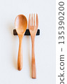 Wooden spoon and fork and cutlery rest on white background 135390200