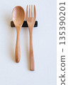 Wooden spoon and fork and cutlery rest on white background 135390201