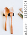Wooden spoon and fork and cutlery rest on white background 135390203