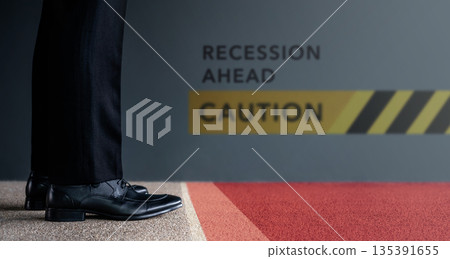 Businessman standing before recession ahead warning sign. Concept of economic recession 135391655