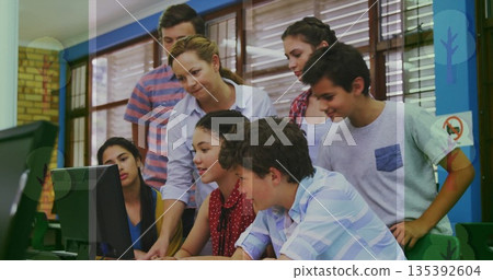 Teacher in white blouse guiding students in school computer lab, with keyboard and mouse Teacher in white blouse guiding students in school computer lab, with keyboard and mouse 135392604