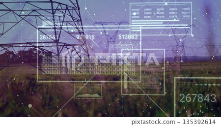 Displaying steel lattice transmission tower standing in grassy field, with digital UI overlays 135392614