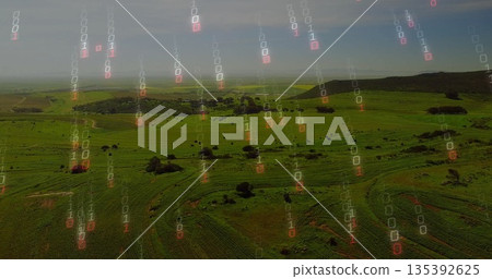 Showing aerial farmland with crop rows unfolding over rolling hills, with binary code overlay Showing aerial farmland with crop rows unfolding over rolling hills, with binary code overlay 135392625