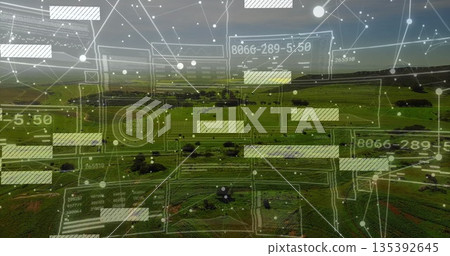 Projecting network overlay over farmland hills at dusk, with translucent grids, nodes and readouts Projecting network overlay over farmland hills at dusk, with translucent grids, nodes and readouts 135392645