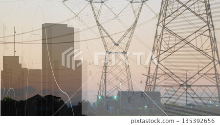 Three steel lattice power towers standing at power substation at dusk, with overhead power lines Three steel lattice power towers standing at power substation at dusk, with overhead power lines 135392656