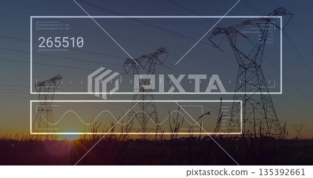 Showing steel transmission tower rising over dusk grass field with cables, translucent data panels 135392661