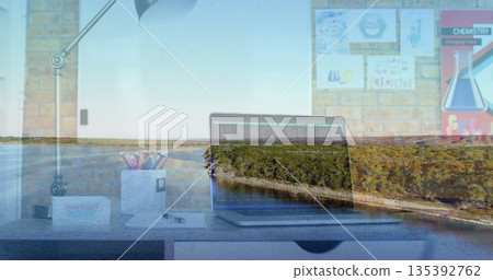 Open laptop displaying code in office workspace, with chemistry posters and riverside overlay 135392762