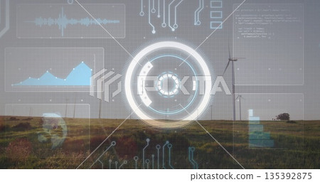 Displaying circular HUD overlaying grassy plain wind farm, with wind turbine towers and data panels 135392875