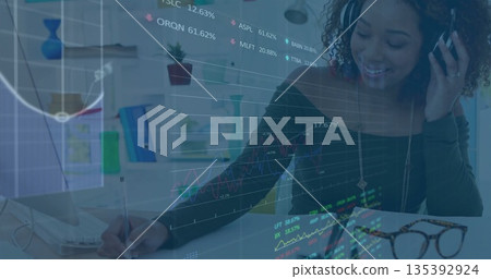 Woman analyzing financial charts and writing notes in home office with laptop notebook, copy space Woman analyzing financial charts and writing notes in home office with laptop notebook, copy space 135392924