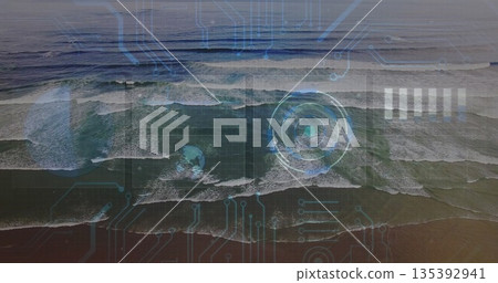 Revealing aerial view showing rolling ocean waves at sandy shoreline, circular HUD circuit overlay Revealing aerial view showing rolling ocean waves at sandy shoreline, circular HUD circuit overlay 135392941