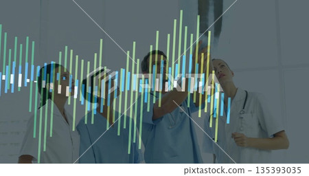 Analyzing nurses in scrubs and doctors reviewing scan display in radiology room with bar graph Analyzing nurses in scrubs and doctors reviewing scan display in radiology room with bar graph 135393035