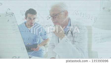 Discussing medical data senior physician and trainee examining laptop at desk, math equations 135393096