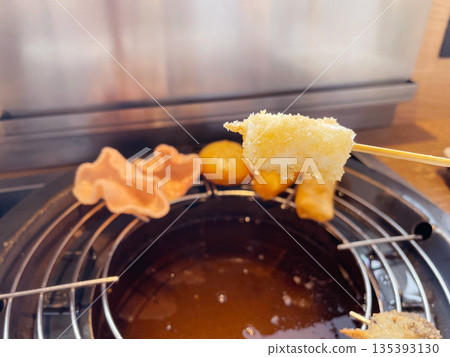 Deep-fried mozzarella cheese skewers, melted cheese fried on a skewer Deep-fried mozzarella cheese skewers, melted cheese fried on a skewer 135393130