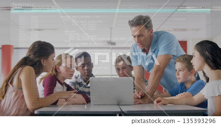 Guiding male instructor leaning over table instructing students at lab, with laptop code overlay 135393296