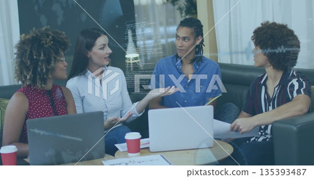 Team of four professionals in business attire sitting and discussing in office lounge, with laptops Team of four professionals in business attire sitting and discussing in office lounge, with laptops 135393487